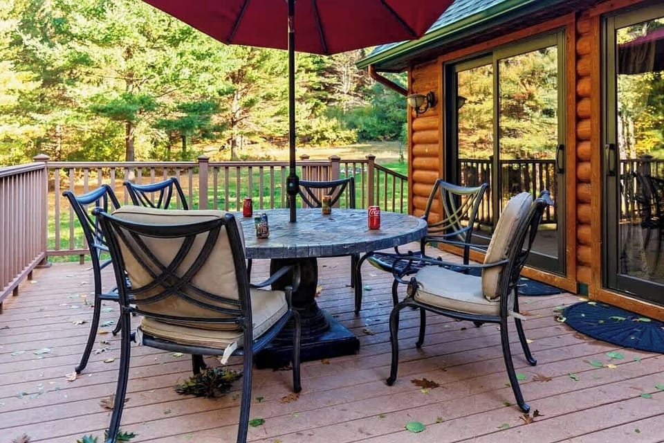 Large private deck surrounded by mature Northern Michigan hardwoods, perfect for morning coffee, evening meals, and unwinding after a day on Torch Lake