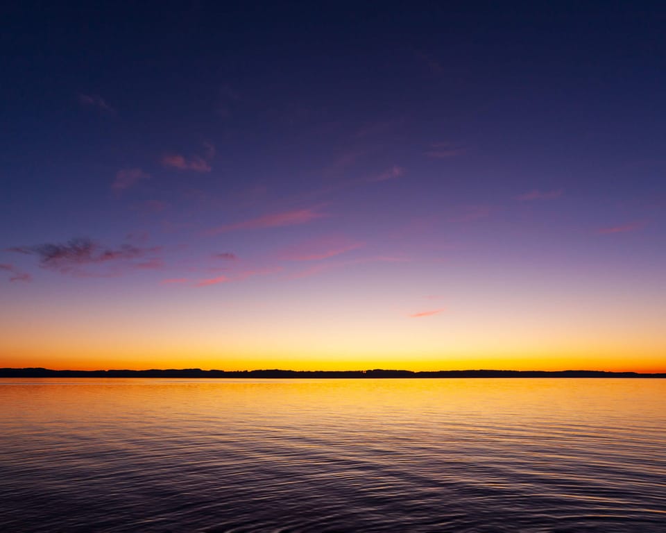 Torch Lake at golden hour — ranked one of the most beautiful lakes in the world, and just minutes from Eagles Landing