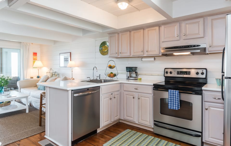 Kitchen with all the kitchen gadgets  you need.  Microwave, coffee grinder & pot