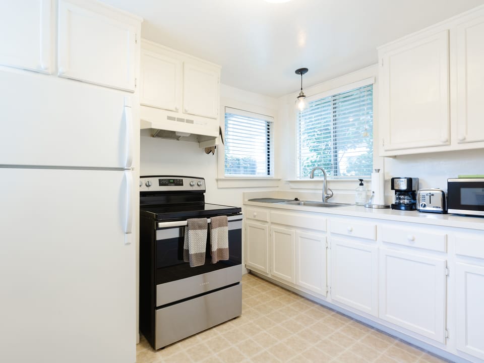 Lots of cabinet space, electric stove, oven and full size refrigerator. 