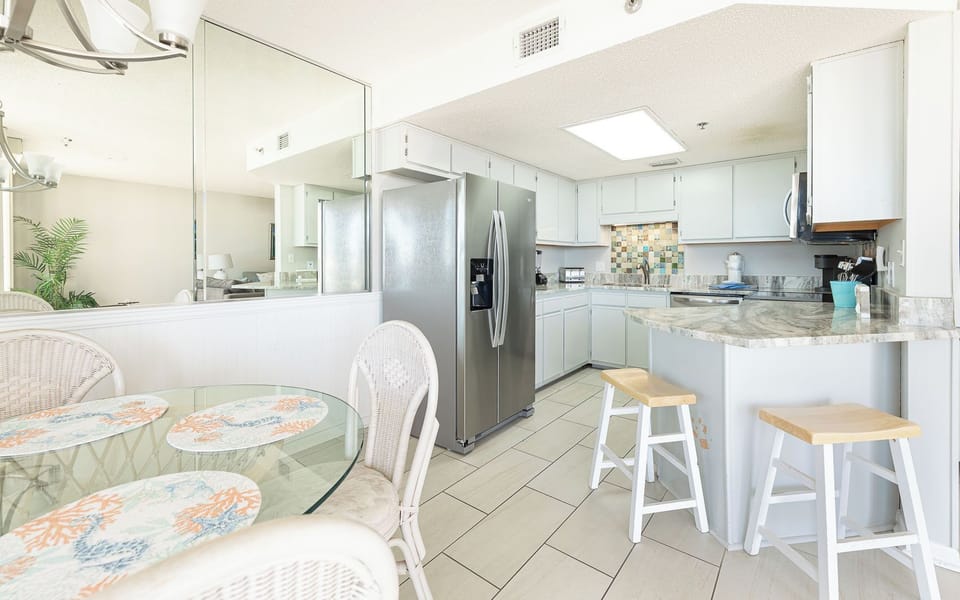 Tastefully tiled backsplash brightens the kitchen where you gather for quick meals and morning coffee