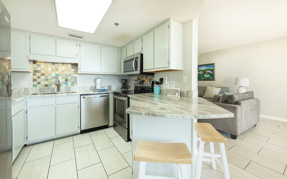 Brew a fresh cup at the coffee maker as you settle into the kitchen's smooth marble counter seating