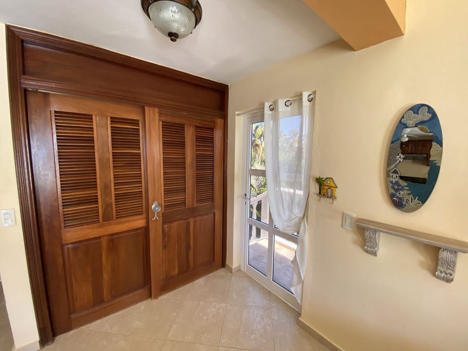 Entrance to condo with laundry closet 
