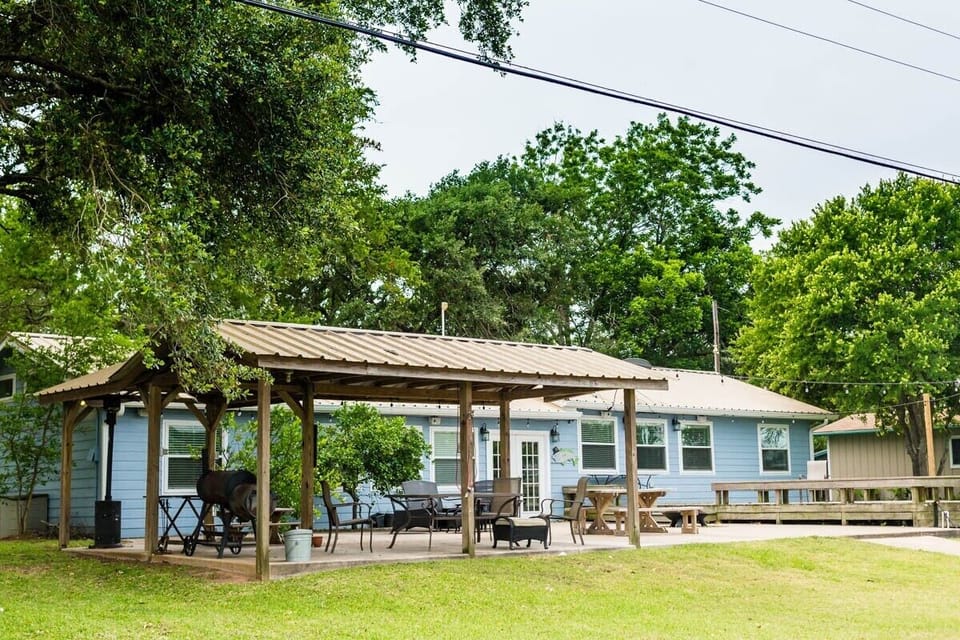 Covered BBQ area and outdoor dining area. Picnic tables and large deck as well.