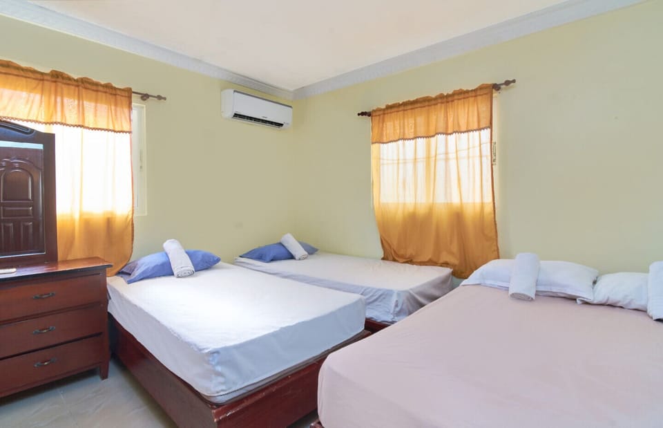 Air conditioned Bedroom with 1 double bed and 2 single beds