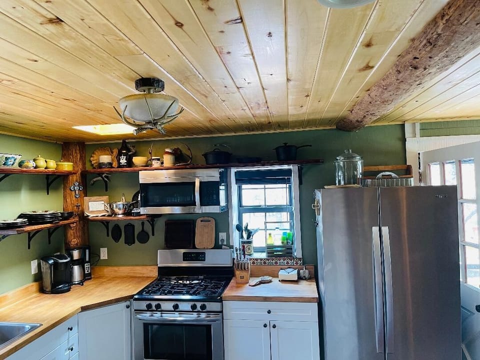 Aspen ceiling beams add character to the kitchen, open to the dining area.