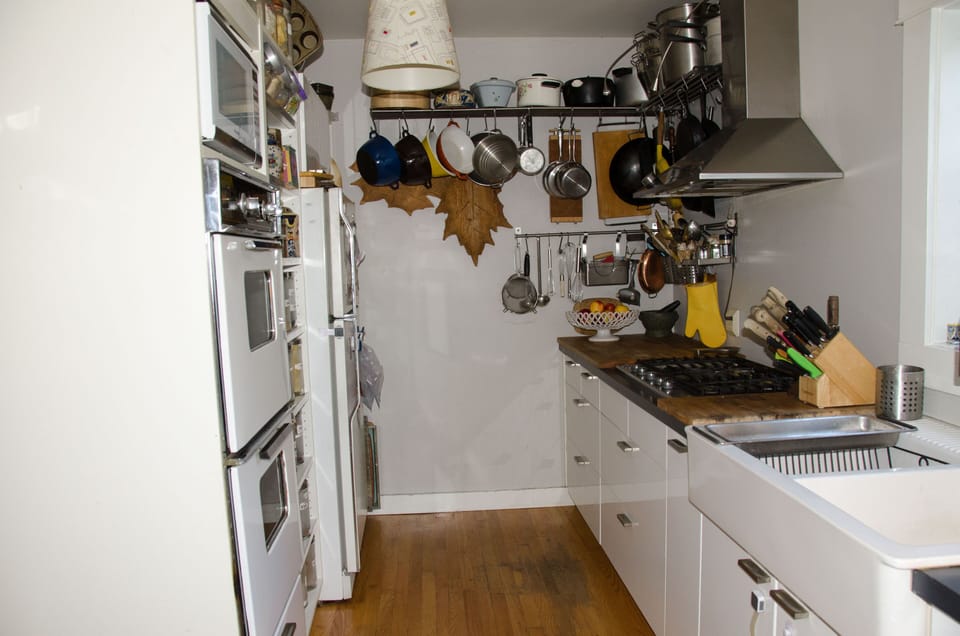 Kitchen with Kitchen Aid gas stove, double wall oven, LG fridge and prep area