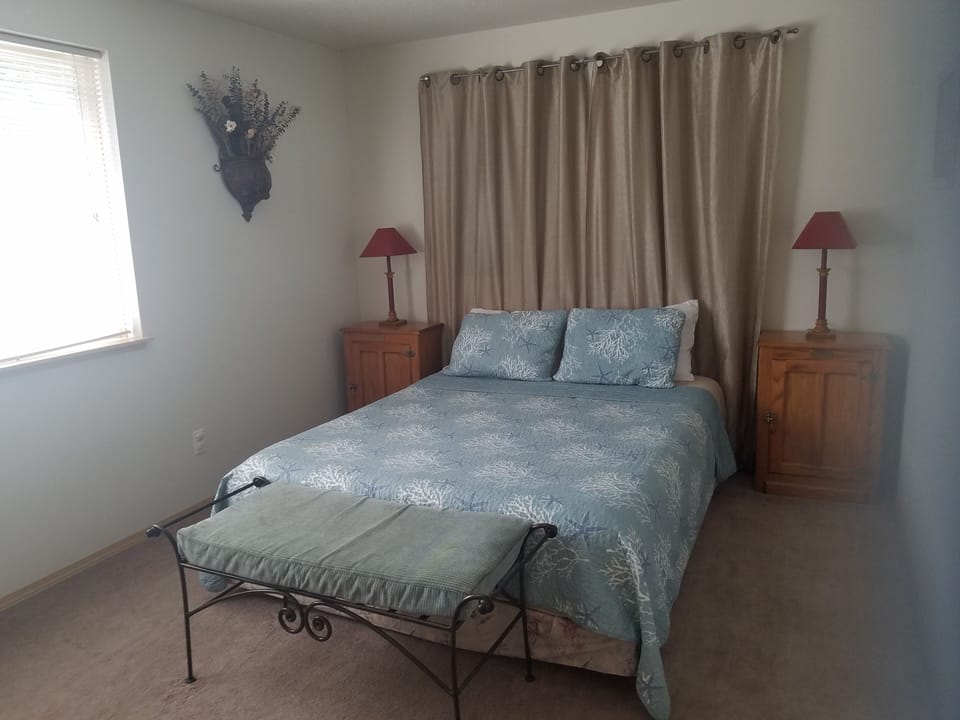 Main floor bedroom 1 has a queen bed and overlooks the lake