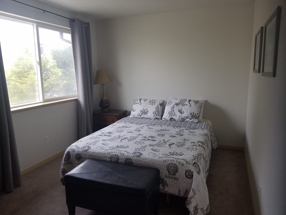 Upstairs bedroom has a queen bed and a desk