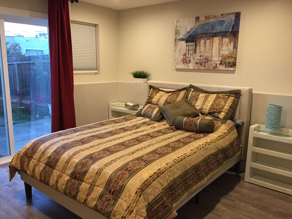 Bedroom with queen bed and access to garden