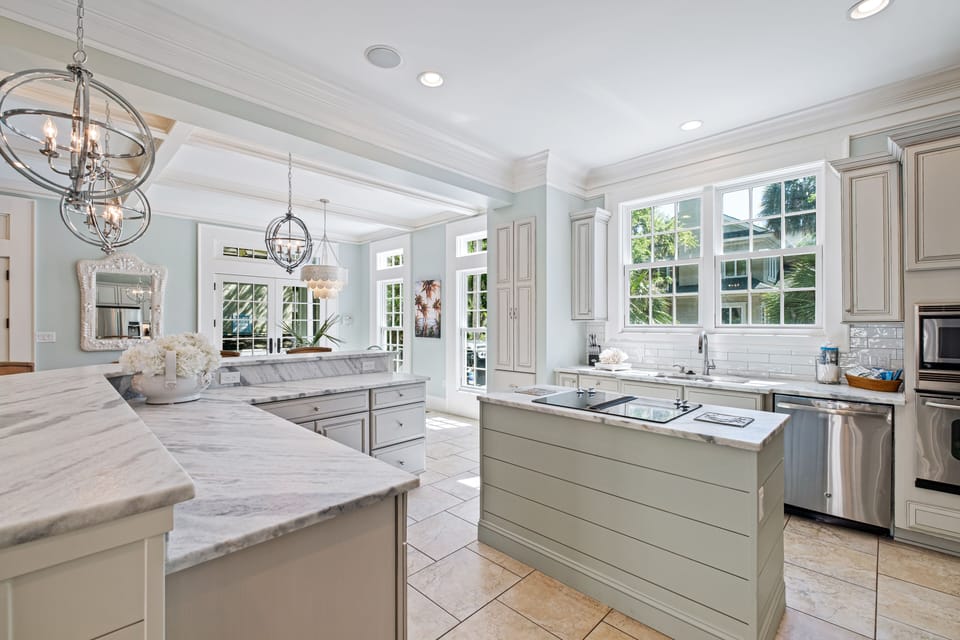 Newly remodeled kitchen with a view out the window to the pool deck spa area