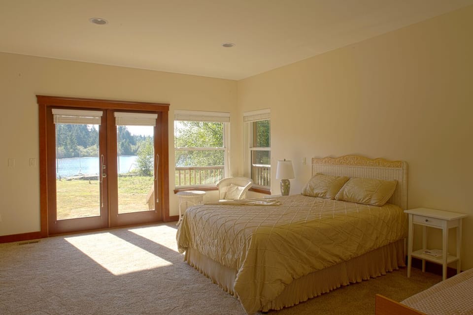 Master bedroom with doors to waterfront.