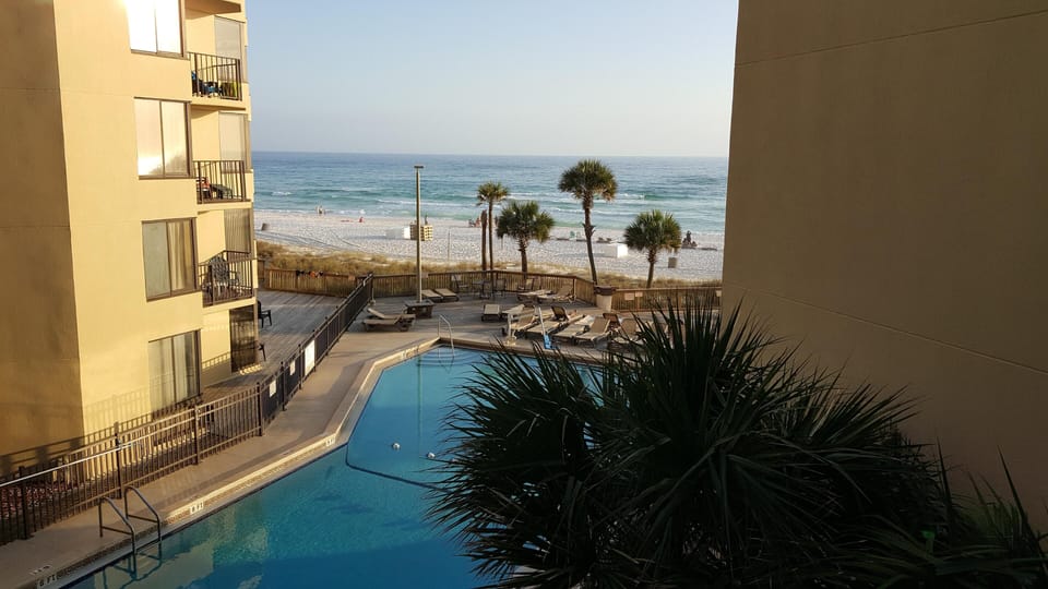 Sit out on balcony and enjoy the pool view and the beach view! 