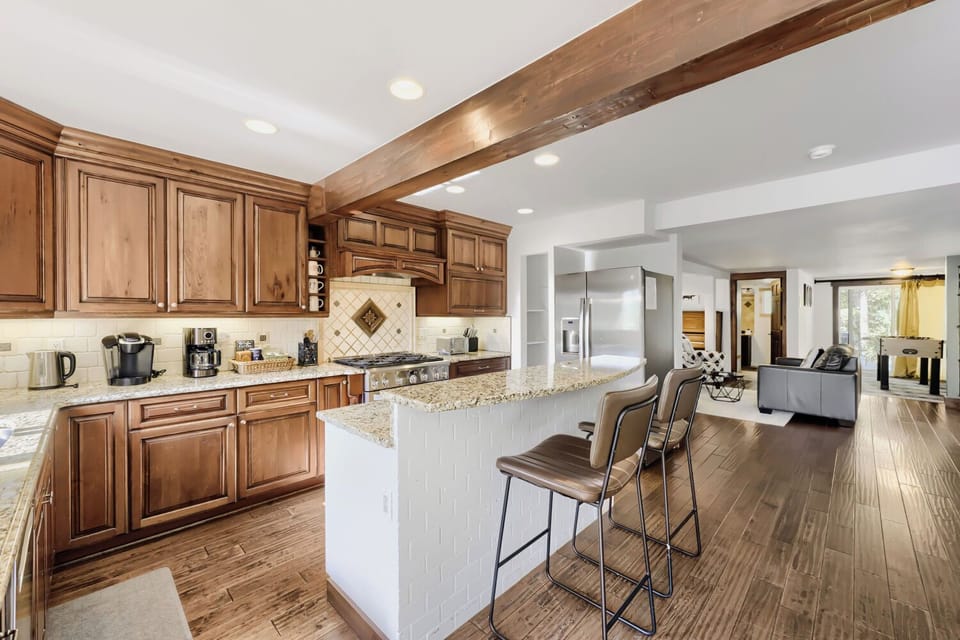 Gather around the spacious kitchen island with granite counters, custom cabinetry, and modern appliances—everything you need to cook memorable meals together in your home away from home.