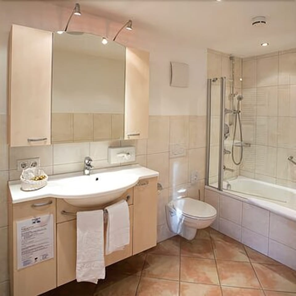 Deep soaking tub, hair dryer, slippers, towels