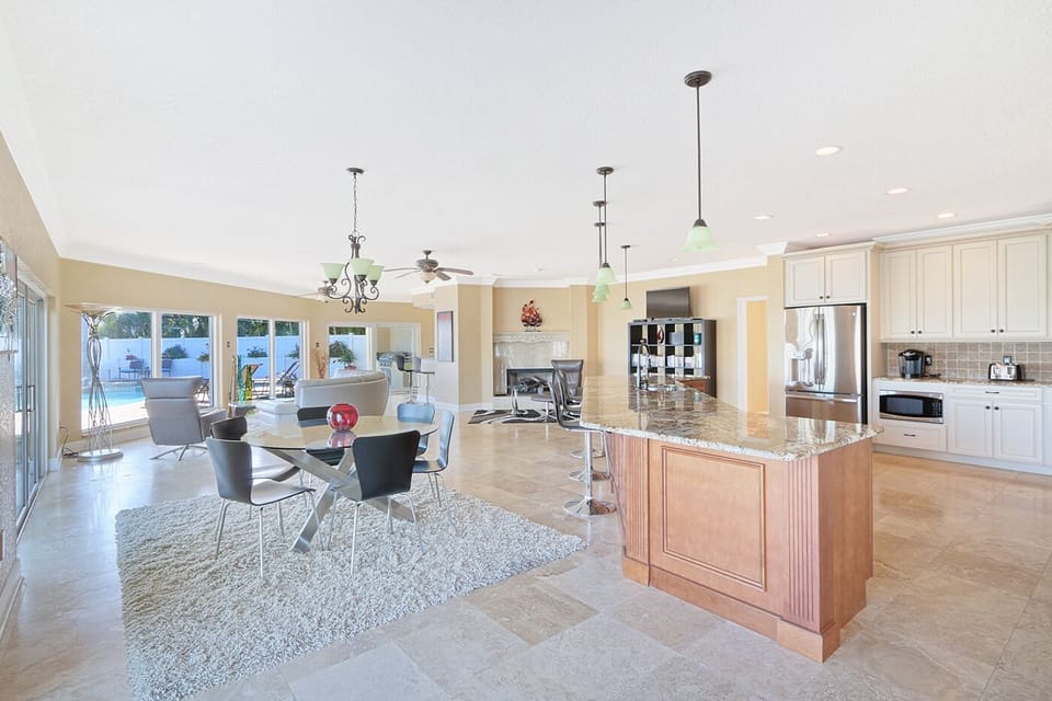 Main living area- kitchen, dining area in foreground; fireplace, seating beyond.