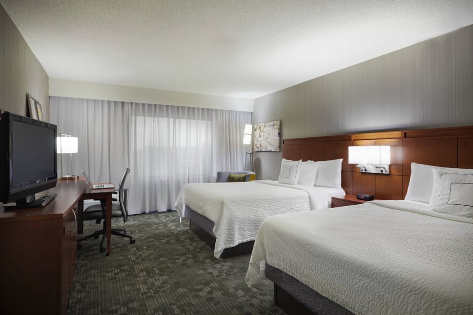 Room, 2 Queen Beds, Courtyard View | Desk, blackout drapes, iron/ironing board, free cribs/infant beds