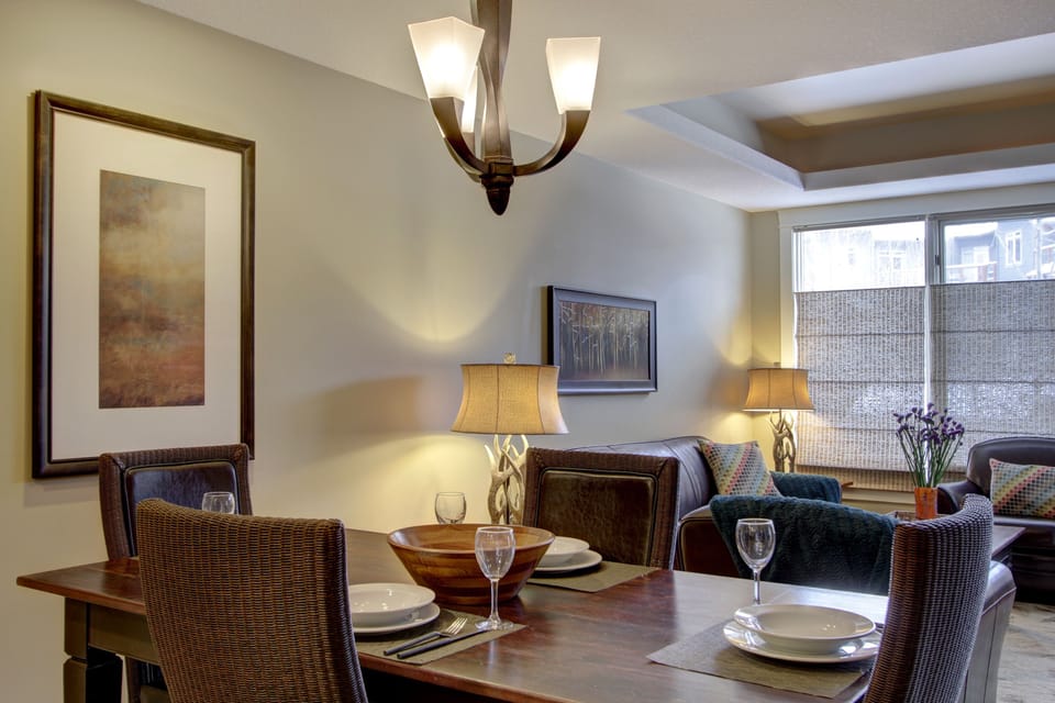The bright, open floor plan includes easy access and sight lines through the dining and living areas, which includes a coffered ceiling.