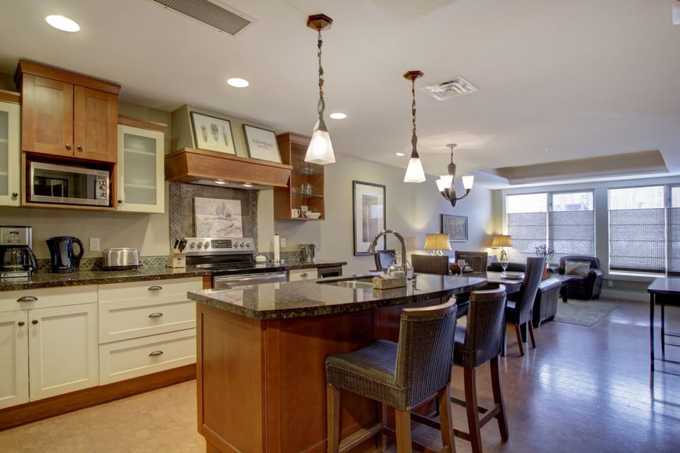The gourmet, eat-in kitchen is fully stocked and features stainless steel appliances.