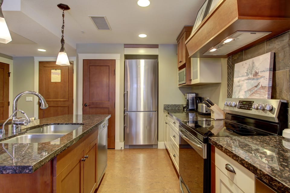 The gourmet, eat-in kitchen is fully stocked and features stainless steel appliances.