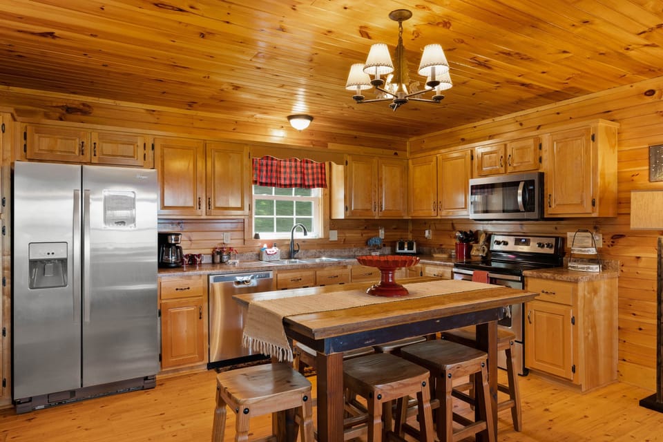 Spacious kitchen w/custom birch cabinetry, stainless appliances & hand crafted dining table