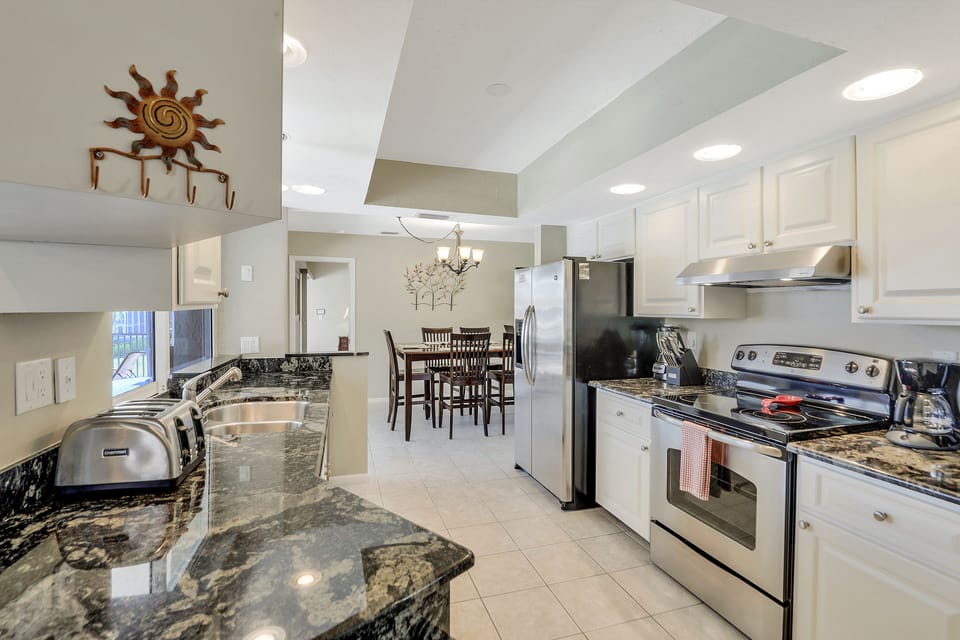Double sink overlooking pool & canal, equipped with all basic cooking needs!