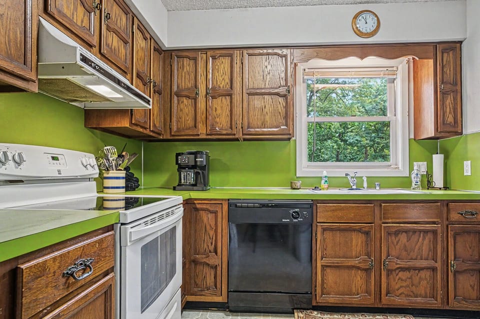 Cook up your favorite meals in this well-equipped kitchen with classic wood cabinetry, bright green countertops, and all the appliances you need for a comfortable stay.