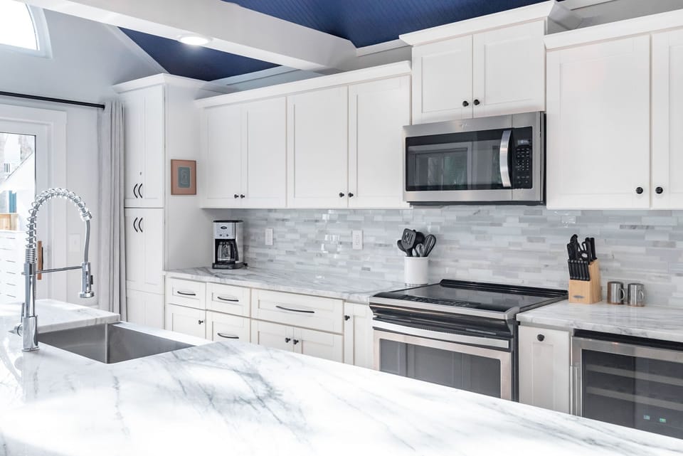 This amazing kitchen boasts custom cabinets and modern appliances.