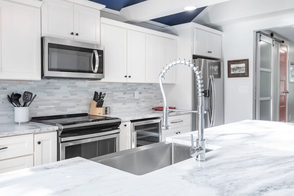 This amazing kitchen boasts custom cabinets and modern appliances.
