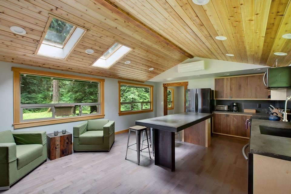 Antique modern chairs, handmade stack table by local artist, skylights and views