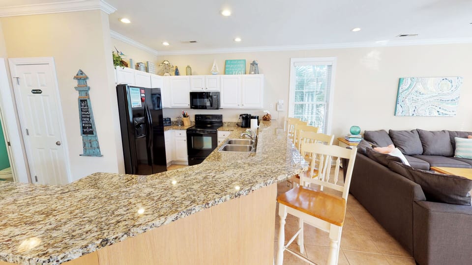 Bright and functional kitchen with ample counter space for easy vacation cooking and entertaining.