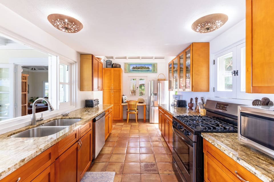 The gallery style kitchen is bright & airy & well equipped to prepare any feast