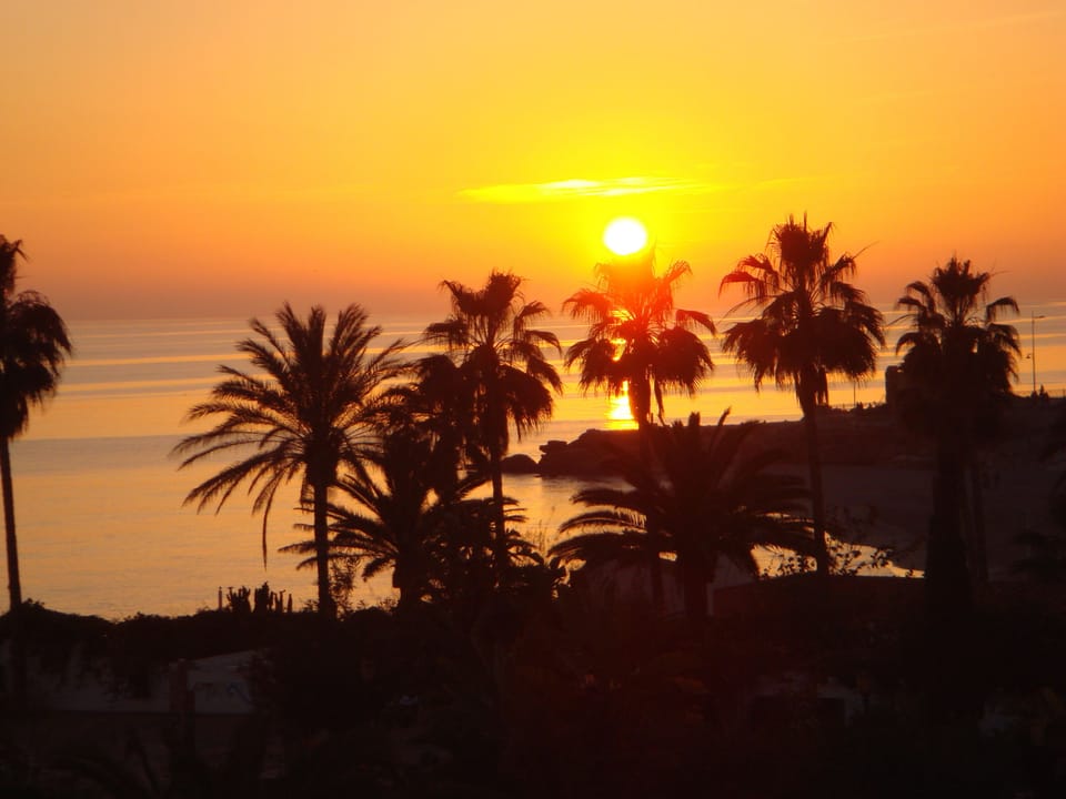 Enjoy the beautiful sunsets from the apartment balcony with a glass of wine.