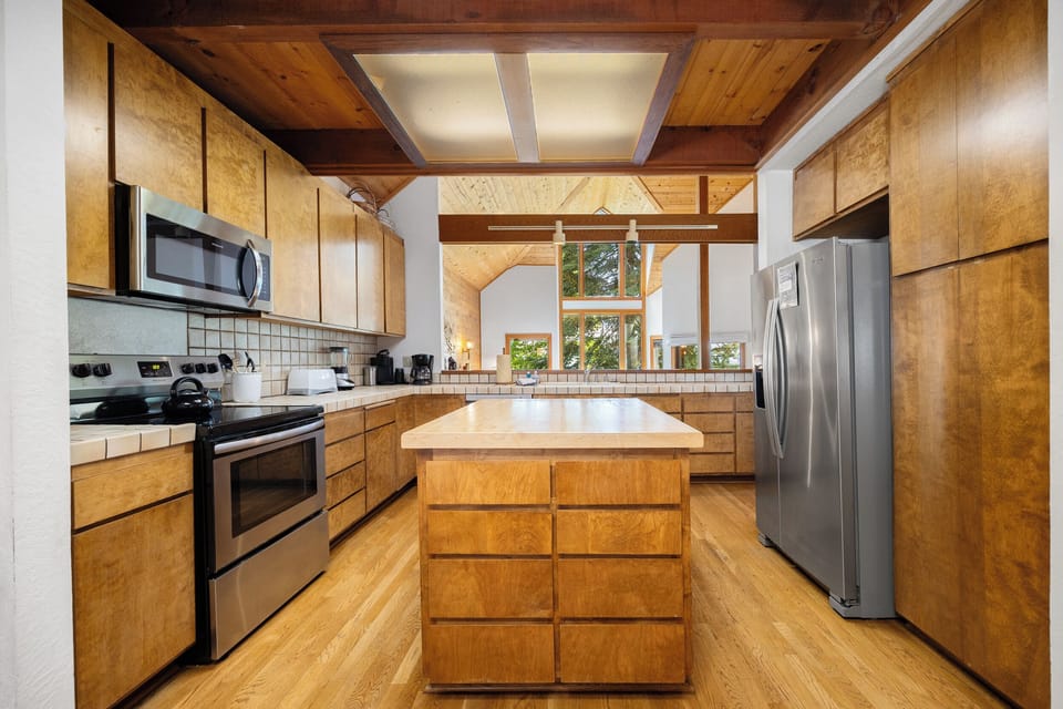 Open kitchen with large island - new oven not pictured