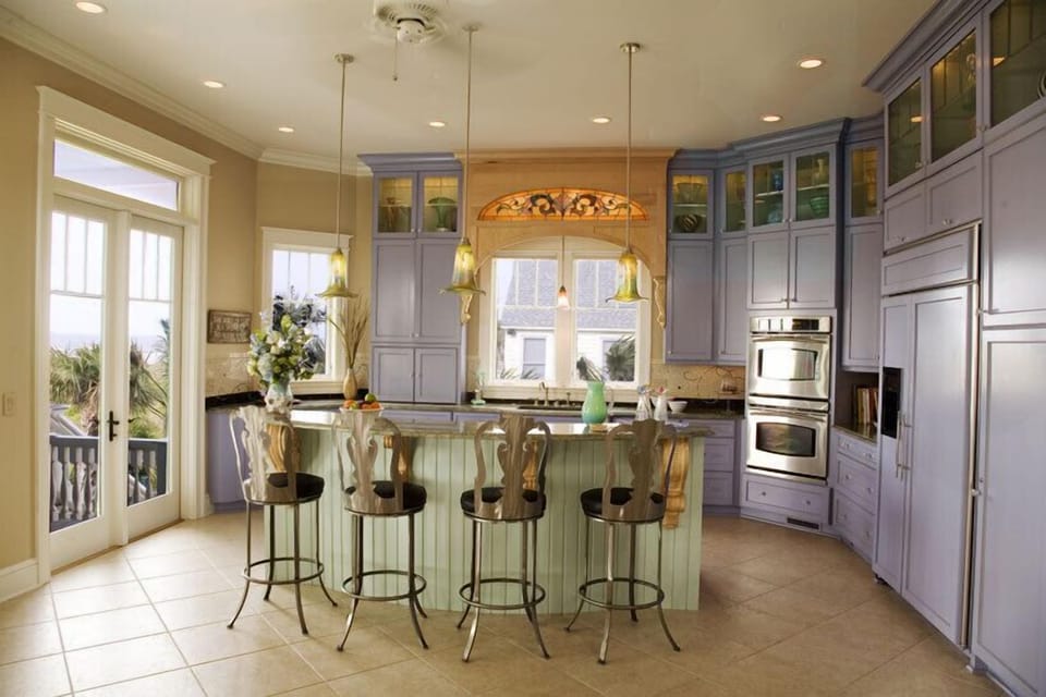 Gourmet Kitchen-  granite counters/subzero.  Doors lead to outdoor teak table