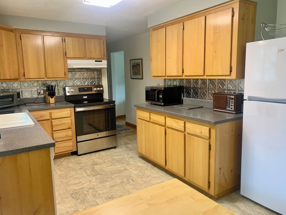 Glass top range, Beko fridge,a microwave, -- and an antique stereo AM/FM radio!