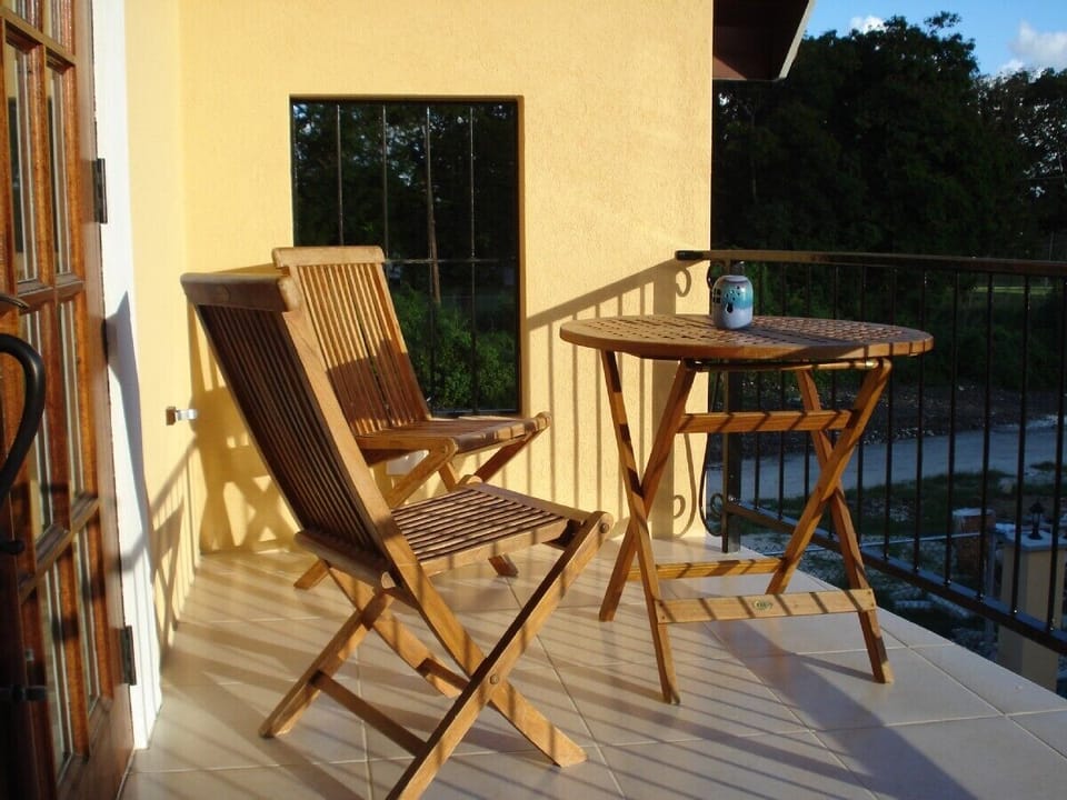 Balcony equipped with table, chairs & sun umbrella