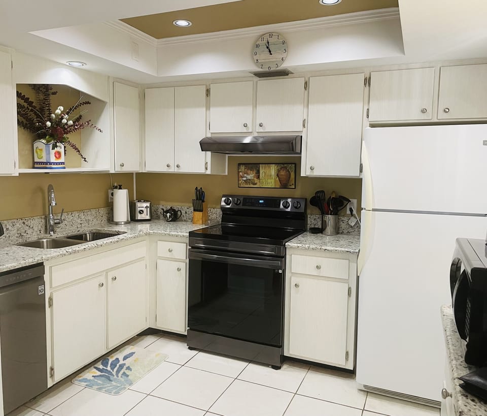 Well equipped kitchen with new quartz countertops, sink, dishwasher..