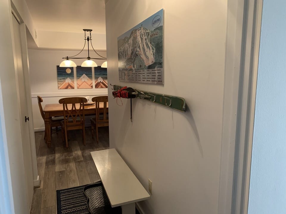 Ski coat rack in the foyer plus a large map of the ski trails.