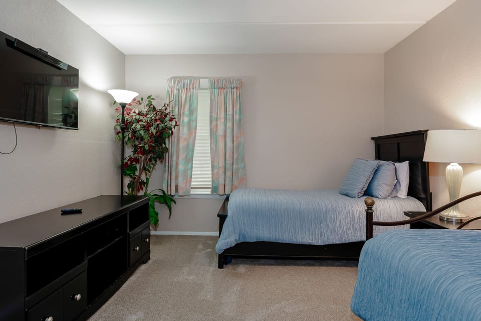 Our 2nd guest room has closet and dresser space to keep your spaces tidy and a flat screen TV for the perfect movie night.