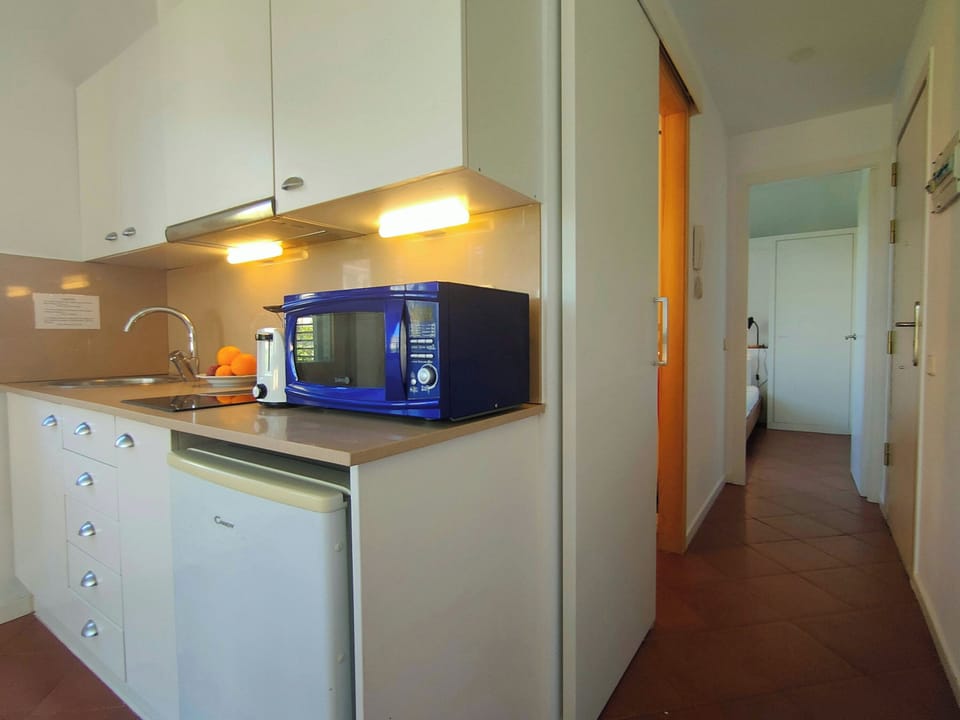 This inviting and functional kitchen offers everything you need to prepare a simple meal or enjoy a quick snack.