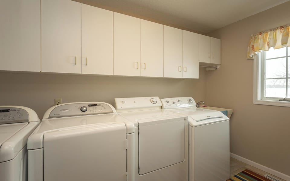 Main level laundry room off of the kitchen. Double washers and dryers.