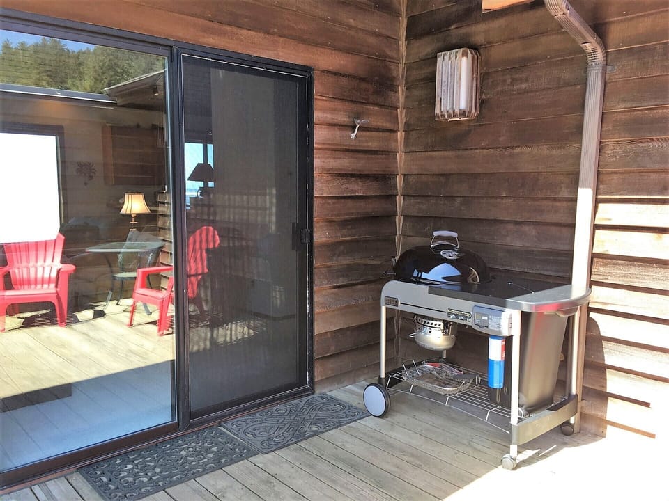 Sliding glass door and BBQ.  This deck is enclosed with a fence.
