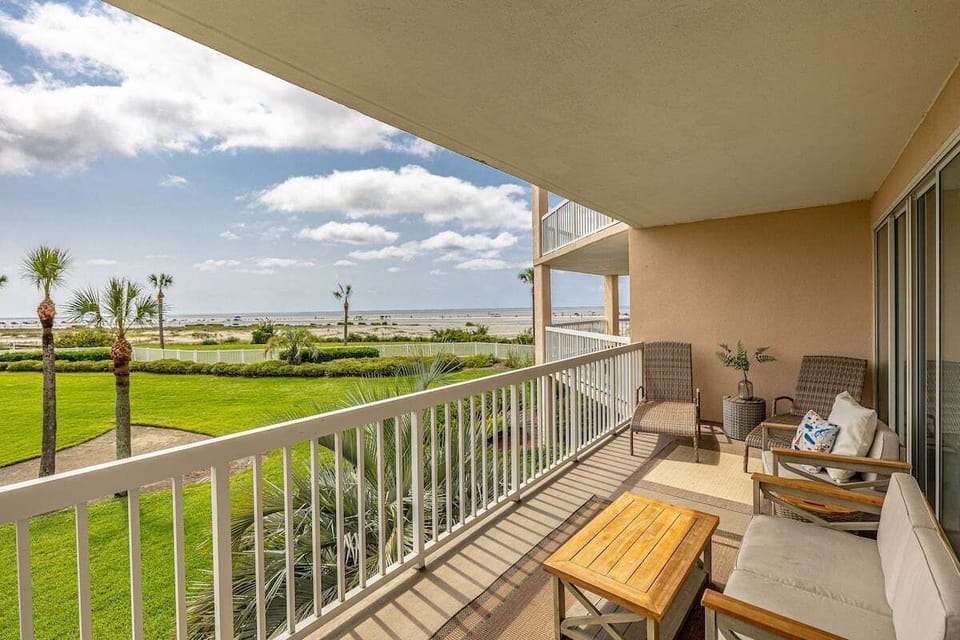 St. Simons Grand #102 Patio with Beach view, tables, and chairs