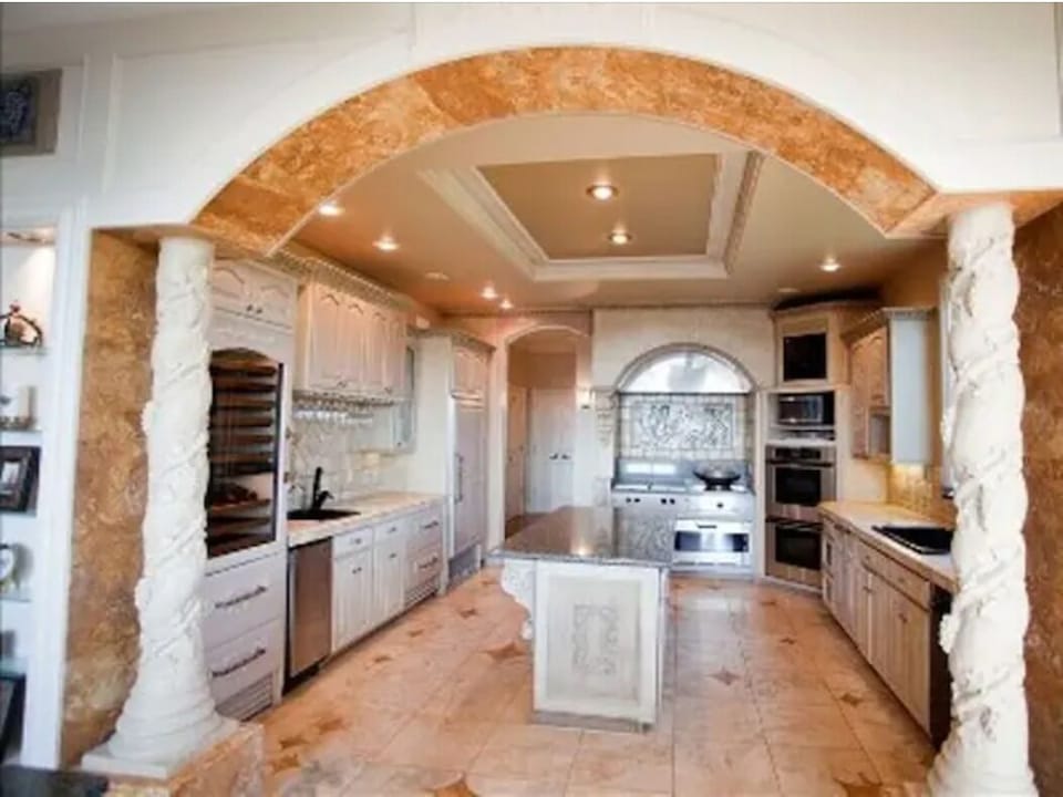 Gourmet kitchen: 3 ovens, built in wok, wine refrigerator, & warming drawers  