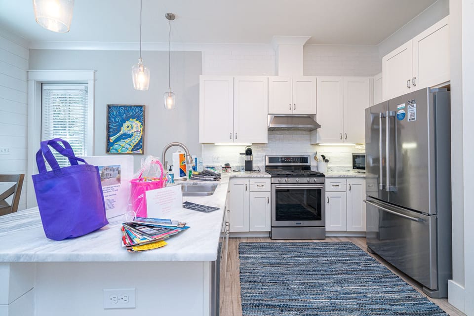 Gourmet kitchen with large island, open to living/dining.  Access to back patio