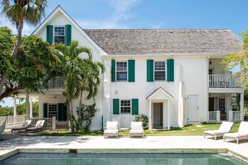 Back yard and pool. Plenty of lounge chairs, plus more under the pool cabana.