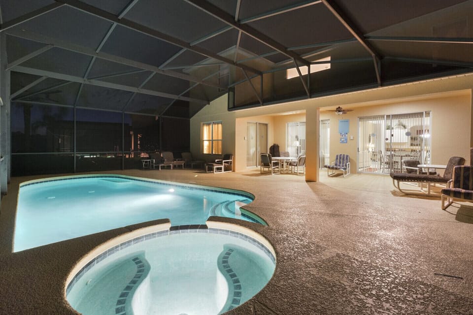 An evening view of the pool and spa