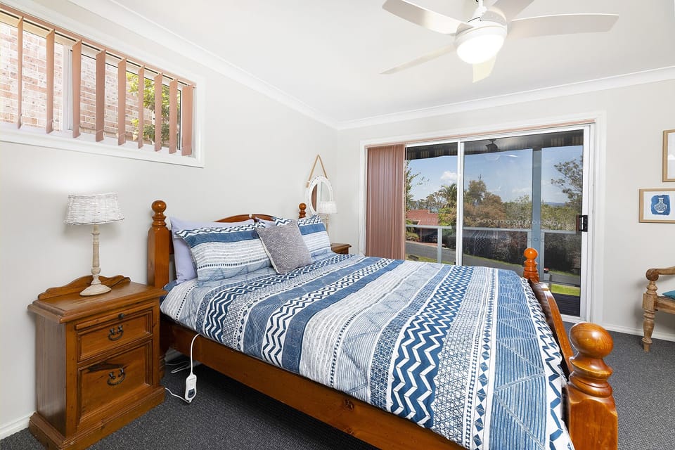 The master bedroom with a queen size bed and lake views