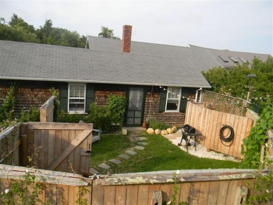 Crushed oyster shell BBQ area & outside shower on right.